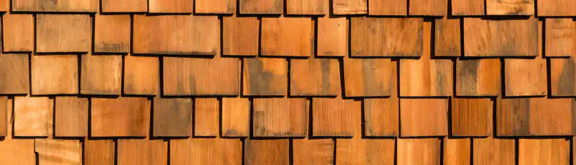 Cedar shake roof being installed on a residential home, showcasing craftsmanship and quality materia.