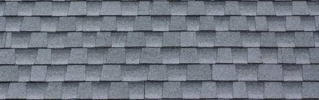 Expert installation of architectural shingles on residential roof by Home Team Construction.
