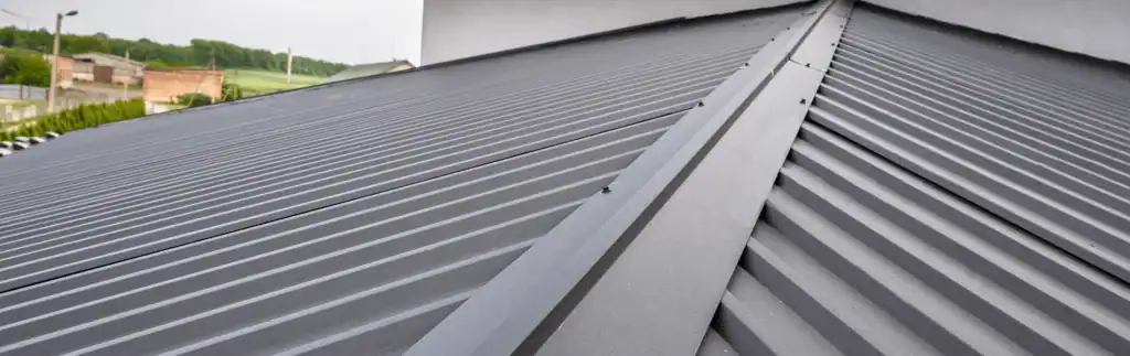 Metal roof installation on a residential building with durable, weather-resistant panels.