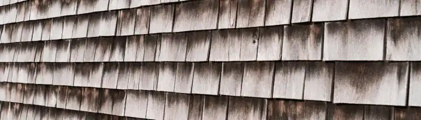 Cedar shake siding being repaired on a residential home. Expert craftsmanship by Home Team Construct.