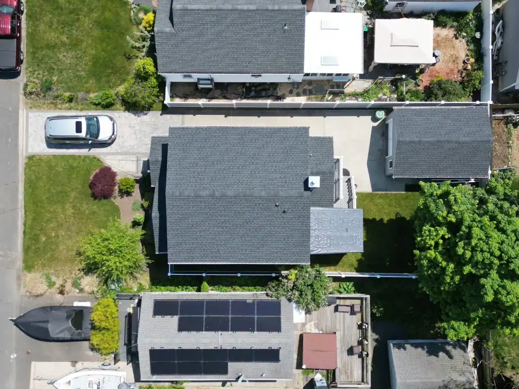 Aerial view of a residential property with solar panels on the roof.