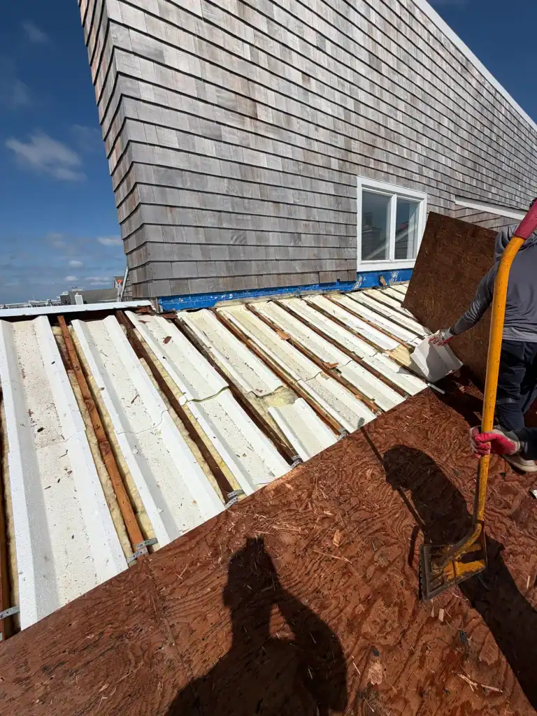 Roof construction with wooden and metal materials on a building.