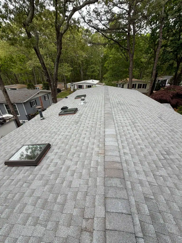 Newly installed gray shingle roof on a residential home with skylights.