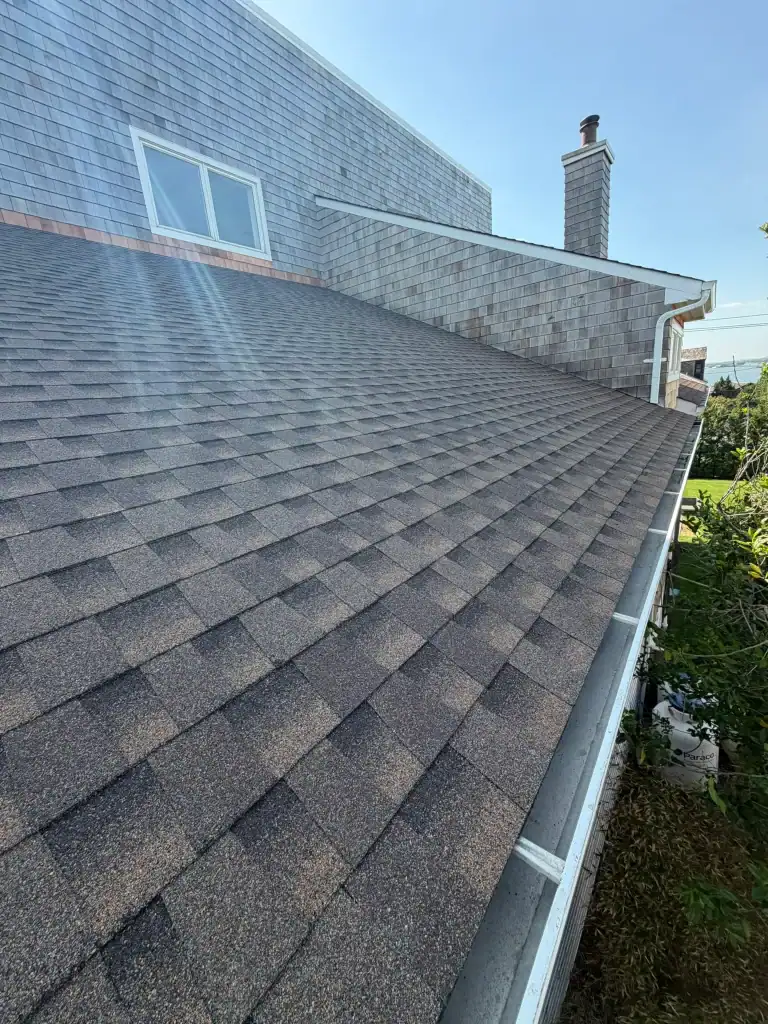 Newly installed asphalt shingle roof on residential home in Long Island.